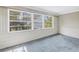 Sun room boasting a wall of windows with a serene view of trees and water at 2028 Blossom S Way, St Petersburg, FL 33712