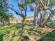 Well-manicured front lawn with mature shade trees, enhancing the curb appeal of this home at 2606 Oak Cir, Tarpon Springs, FL 34689