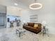 Cozy living room with a comfortable brown sofa, stylish rug, and bright lighting perfect for relaxing or entertaining at 2606 Oak Cir, Tarpon Springs, FL 34689