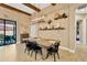 Elegant dining area featuring wooden beams, modern lighting, and a large dining table at 2677 Northwood Park St, Valrico, FL 33596