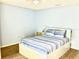 Cozy bedroom with a queen-sized bed and hardwood floors at 6262 142Nd Ave # 506, Clearwater, FL 33760
