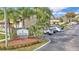 Welcome to Via Verde, a deed-restricted community; the sign sits in front of a tan condo building with reserved parking spaces at 6262 142Nd Ave # 506, Clearwater, FL 33760