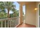 Private balcony area featuring white railings and an outside view with foliage at 1216 S Missouri Ave # 224, Clearwater, FL 33756