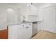 Updated kitchen featuring white cabinetry, stainless steel appliances, and granite countertops at 1216 S Missouri Ave # 224, Clearwater, FL 33756