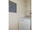 Laundry area featuring a white washing machine, shelving, and electrical panel at 1216 S Missouri Ave # 224, Clearwater, FL 33756