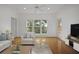 Bright living room featuring hardwood floors, large window, and neutral-toned furniture at 1216 S Missouri Ave # 224, Clearwater, FL 33756