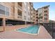 Community pool set by a modern building with balconies, and a brick-paved surround at 1216 S Missouri Ave # 224, Clearwater, FL 33756
