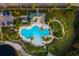 Aerial view showcases a resort-style pool, lush landscaping, and a tranquil community setting at 10534 Bermuda Isle Dr, Tampa, FL 33647