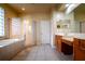 Well-lit primary bathroom with a glass enclosed shower and soaking tub at 10534 Bermuda Isle Dr, Tampa, FL 33647