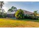 Charming home featuring a tiled roof, lush landscaping, and a screened-in pool area in the backyard at 10534 Bermuda Isle Dr, Tampa, FL 33647