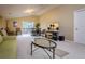 Bright living room featuring neutral walls, vaulted ceilings, comfortable seating, and a sliding glass door to the outside at 10534 Bermuda Isle Dr, Tampa, FL 33647