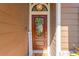 Close-up of the beautiful front door, complete with decorative wreath and welcome sign at 11209 Bloomington Dr, Tampa, FL 33635
