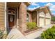 Inviting front entrance featuring a solid wood door, sidelight, and brick accents at 11209 Bloomington Dr, Tampa, FL 33635