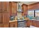 Charming kitchen with wood cabinets, stainless steel appliances, and granite countertops at 11209 Bloomington Dr, Tampa, FL 33635