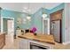 Custom kitchen features wood cabinets, granite countertops, stainless steel appliances, and a butcher block island at 11209 Bloomington Dr, Tampa, FL 33635