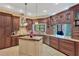 Custom kitchen features wood cabinets, granite countertops, stainless steel appliances, and a butcher block island at 11209 Bloomington Dr, Tampa, FL 33635