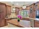 Custom kitchen features wood cabinets, granite countertops, stainless steel appliances, and a butcher block island at 11209 Bloomington Dr, Tampa, FL 33635