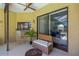 Cozy covered patio featuring comfortable seating, an outdoor ceiling fan, and sliding door access at 11209 Bloomington Dr, Tampa, FL 33635
