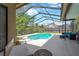 Spacious screened-in pool area with room for seating and attractive landscaping at 11209 Bloomington Dr, Tampa, FL 33635