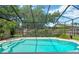 A screened-in pool provides a private oasis with clear water and ample space for relaxation and recreation at 11209 Bloomington Dr, Tampa, FL 33635