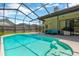 Inviting pool features screened-in enclosure and easy access steps to the clear water at 11209 Bloomington Dr, Tampa, FL 33635