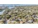 Aerial view of the property close to the intercoastal, showing mature trees and lush landscaping at 1157 Brook Rd, Clearwater, FL 33755