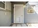 Exterior side entry door, small window and pet door, providing access to the home at 1157 Brook Rd, Clearwater, FL 33755