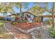 Charming home with a brick walkway, lush landscaping, inviting front porch, and classic chimney at 1157 Brook Rd, Clearwater, FL 33755