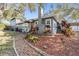 Charming home with a brick walkway, mature trees, and well-maintained landscaping offers great curb appeal at 1157 Brook Rd, Clearwater, FL 33755