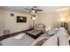 Inviting living room with wood floors, a ceiling fan, and a comfortable sectional sofa at 1157 Brook Rd, Clearwater, FL 33755