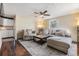 Cozy living room with modern furnishings, a ceiling fan, wood floors, and natural light at 1157 Brook Rd, Clearwater, FL 33755