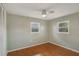 Sunlit bedroom featuring hardwood floors, two windows and a ceiling fan at 12164 84Th N Ave, Seminole, FL 33772