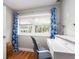 Cozy office nook featuring a modern white desk, a blue chair, and cheerful patterned curtains at 1222 Highland N Ct, St Petersburg, FL 33701