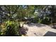 Serene backyard featuring a stone patio, a bar area, and mature trees providing ample shade at 1372 Palmetto St, Clearwater, FL 33755