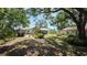 Large backyard with mature trees, a patio, and a gazebo at 1372 Palmetto St, Clearwater, FL 33755