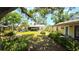Lush backyard with an inviting lawn, mature trees, and additional unit on property at 1372 Palmetto St, Clearwater, FL 33755