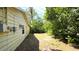View of the backyard with grassy area and trees at 1372 Palmetto St, Clearwater, FL 33755