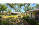 Well-maintained backyard featuring green grass and mature trees at 1372 Palmetto St, Clearwater, FL 33755