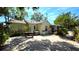 Cozy backyard featuring a brick patio, lush landscaping, and a charming exterior of the home at 1372 Palmetto St, Clearwater, FL 33755