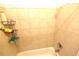Clean and modern tiled shower with built-in shelving for toiletries at 1372 Palmetto St, Clearwater, FL 33755