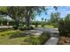 Long concrete driveway lined with grass and green foliage at 1372 Palmetto St, Clearwater, FL 33755