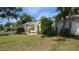 Charming one-story home with a landscaped front yard and blue sky at 1372 Palmetto St, Clearwater, FL 33755