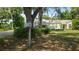 Home exterior featuring a well-maintained lawn, mature landscaping, and a mailbox at 1372 Palmetto St, Clearwater, FL 33755