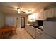 Updated kitchen with white cabinets, a tile floor, and a table with chairs at 1372 Palmetto St, Clearwater, FL 33755