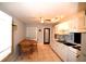 Updated kitchen and eating space with tile floors and white cabinetry at 1372 Palmetto St, Clearwater, FL 33755