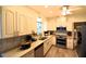 Bright kitchen features white cabinetry, stainless steel appliances, and granite countertops at 1372 Palmetto St, Clearwater, FL 33755