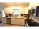 Modern kitchen featuring granite countertops, updated appliances, and ample cabinet space at 1372 Palmetto St, Clearwater, FL 33755