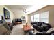 Bright living room featuring tile floors, fireplace, ceiling fan, and large windows at 1372 Palmetto St, Clearwater, FL 33755