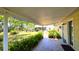Inviting covered patio features tile flooring, lush landscaping, and a relaxing outdoor space at 1372 Palmetto St, Clearwater, FL 33755