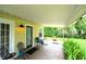 Outdoor patio with chairs, table and tile flooring for relaxing and entertaining at 1372 Palmetto St, Clearwater, FL 33755